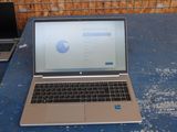 a laptop computer sitting on a table in front of a brick wall
