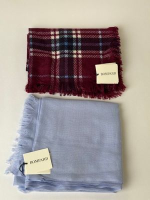 a scarf and a scarf tag on a white surface