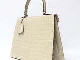 an image of a white handbag on a white background