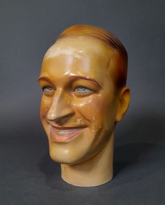 a statue of a man with a smile on it ' s face