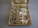 a box with silver figurines in it on a table