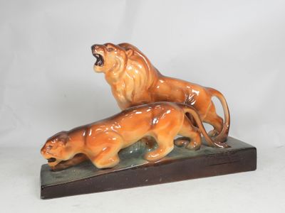 a figurine of a lion and a lion cub on a base