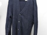 a close up of a sweater on a hanger on a wall
