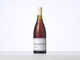 the bottle of wine is sitting on a table with a white background