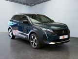 the blue suv is parked in a large room with a white wall