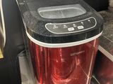 a red toaster sitting on top of a kitchen counter