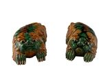 une paire de figurines « foo foo foo » vertes et marron sur fond blanc