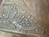 a close up of a fireman ' s helmet on a pink background
