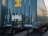 two semi trucks parked next to each other in a parking lot