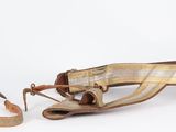 a brown purse and a brown shoe on a white surface