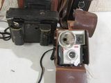 two cameras and a case sitting on a table