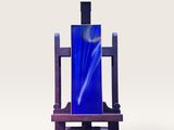 une bouteille en verre bleue posée sur un socle en bois
