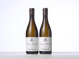 two bottles of wine sitting on top of a table next to each other