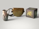 two vases and a box sitting next to each other
