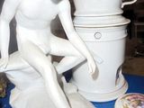 a statue of a man that is sitting on a table