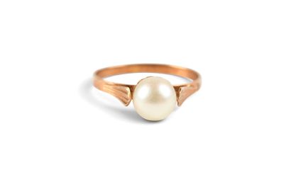 a close up of a pearl ring on a white background