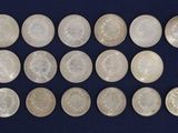 a close up of a bunch of coins on a blue surface