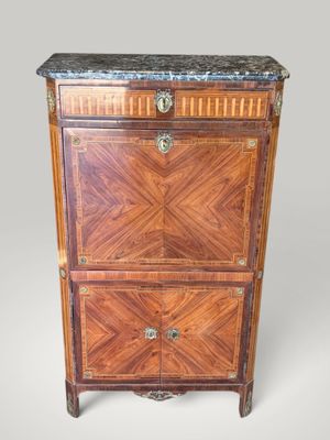 an antique wooden cabinet with marble top and drawers