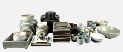 a lot of plates and bowls and bowls on the table