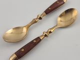 two spoons and a spoon with a wooden handle on a white surface