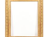 an antique gold frame with a white background