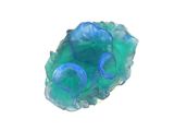 un objet bleu et vert sur une surface blanche