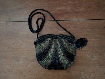 a small purse that is sitting on a wooden floor