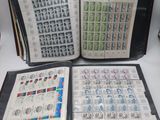 an open book sitting on top of a table covered in stamps