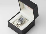 a watch in a black box on a white surface