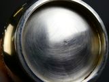 a metal object that is sitting in a persons hand