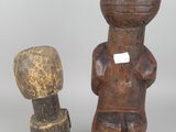 two small wooden figurines of a man and a woman