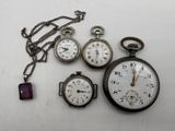 many different types of pocket watches on the table