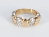 a close up of a gold and diamond ring on a white surface