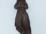 a statue of a woman that is on the wall