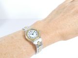 wrist shot of a woman ' s wrist with a watch on it