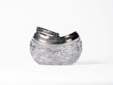 a silver object that is sitting on a white surface