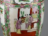 a vase with a painting on it sitting on a table
