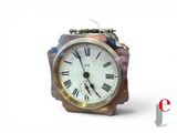 a small clock with roman numerals on the face