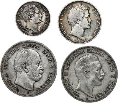 four different types of silver coins, one of which has a man ' s face and one of which has a woman ' s head