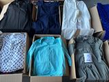 several boxes of clothing are stacked on top of each other on the floor