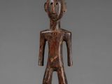 a wooden figure of a man with a head and arms