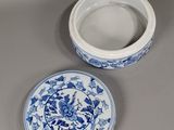 a blue and white bowl and a white bowl on a table