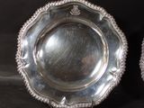 pair of silverplated dishes on stand on black background
