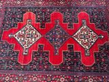 an oriental rug with a red and blue design on it