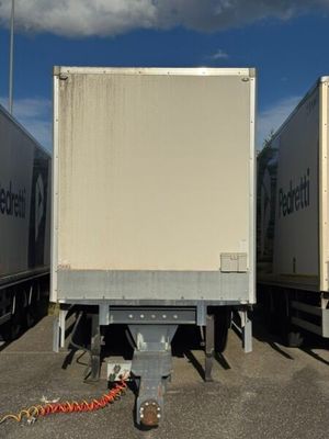 three trucks that are parked in a parking lot