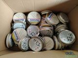 a cardboard box filled with many different types of tins