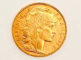 an image of a close up of a gold coin on a white surface