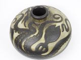 a black and white vase with a design on it