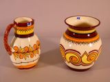 two vases sitting next to each other on a table