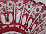a red and white bowl with a pattern on it